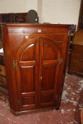 A 19th Century mahogany corner cupboard with arched panelled doors enclosing shelves. 90cm wide x