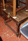 An 18th Century and later oak side table with a frieze drawer on ring turned legs joined by