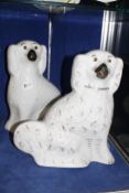 A pair of late 19th c Staffordshire pottery seated hearth spaniels. £30-50