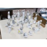 A selection of Lladro figurines, to include cherub musicians, girl with geese and sleepy children (