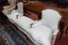 A pair of Louis XV style fauteuils and a matching footstool £350-450