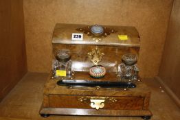 A Victorian walnut stationery cabinet and inkstand, the raised back with curved hinged cover,