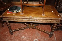 A late 19th century carved oak center table with a spiral cross stretcher, 130cm long, 70cm deep,