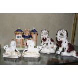 A 19th c Staffordshire pottery cottage, a seated pottery dog, a pair of porcelain models of a lion