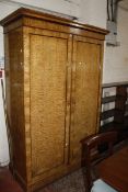 A 19th Century satinwood wardrobe enclosing hanging space and drawers 208cm high, 141cm wide £200-