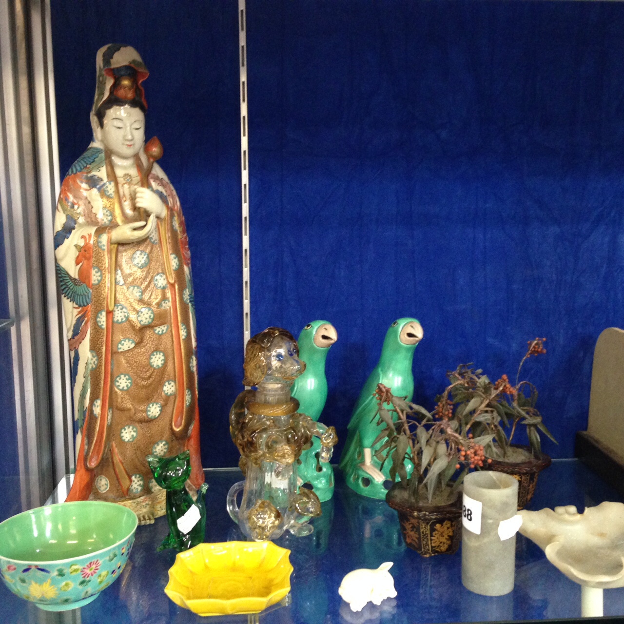 A Japanese Satsuma style figure (a.f.), , two Oriental style parrots, a Venetian glass begging dog