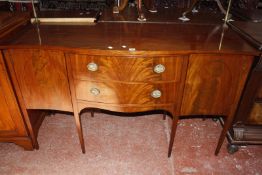 A Regency style mahogany serpentine fronted sideboard with brass curtain rail.153cm wide.