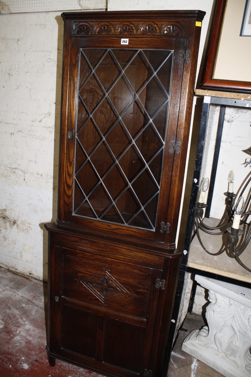 A carved oak floor standing corner cupboard 183cm high, 69cm wide £50-80