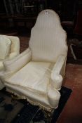 A Continental high arch back elbow chair on gold painted supports. £100-200