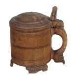 A Scandinavian carved and stained birch peg tankard, 18th century, the domed circular cover