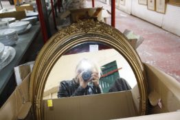 A pair of oval gilt framed mirrors, another in moulded frame and a Victorian black and white