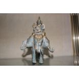 A verdi gris gold finished bronze figure of Indra riding Erawan the three headed elephant.20cm high.