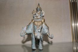 A verdi gris gold finished bronze figure of Indra riding Erawan the three headed elephant.20cm high.