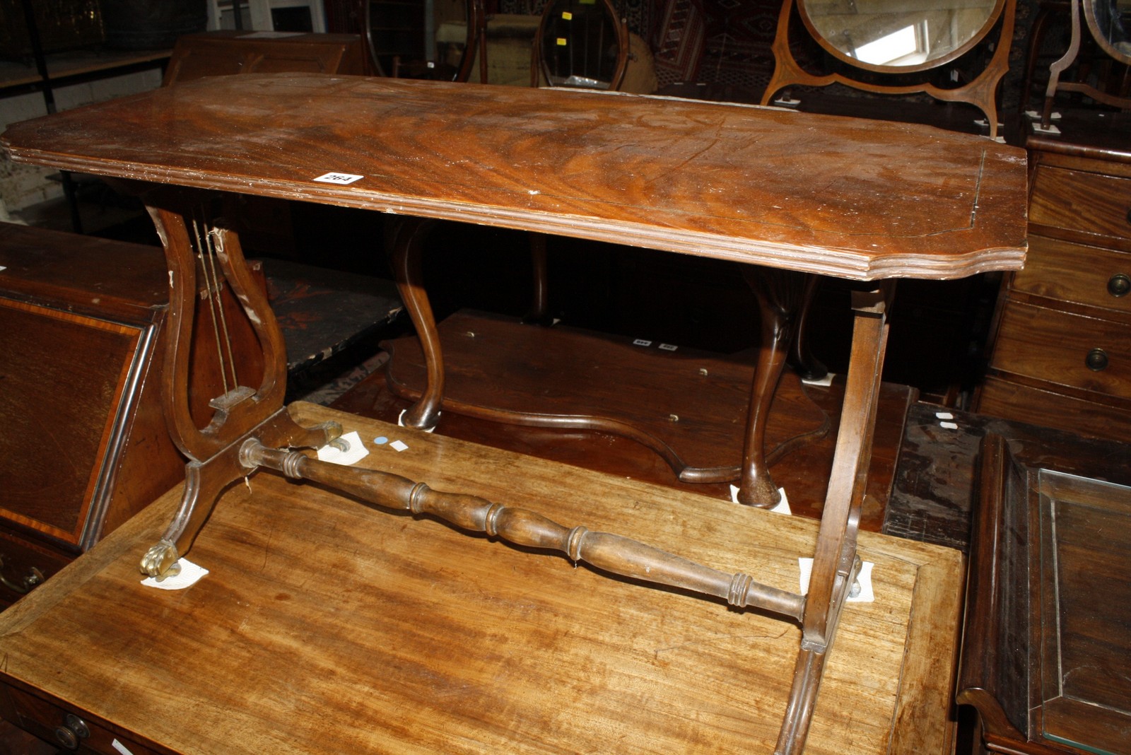 A mahogany table on lyre supports joined by turned stretcher bearing label: 'Shaw of London' 52cm