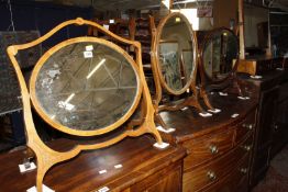 A late Victorian mahogany and inlaid oval swing mirror, together with two further swing mirrors £