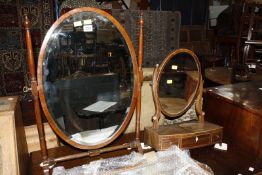 A George II style burr walnut fretwork mirror 68cm high 40cm wide, an oval swing toilet mirror,