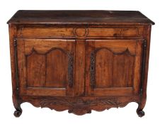 A French oak side cabinet, 18th century, the top with moulded edge above a carved frieze and two