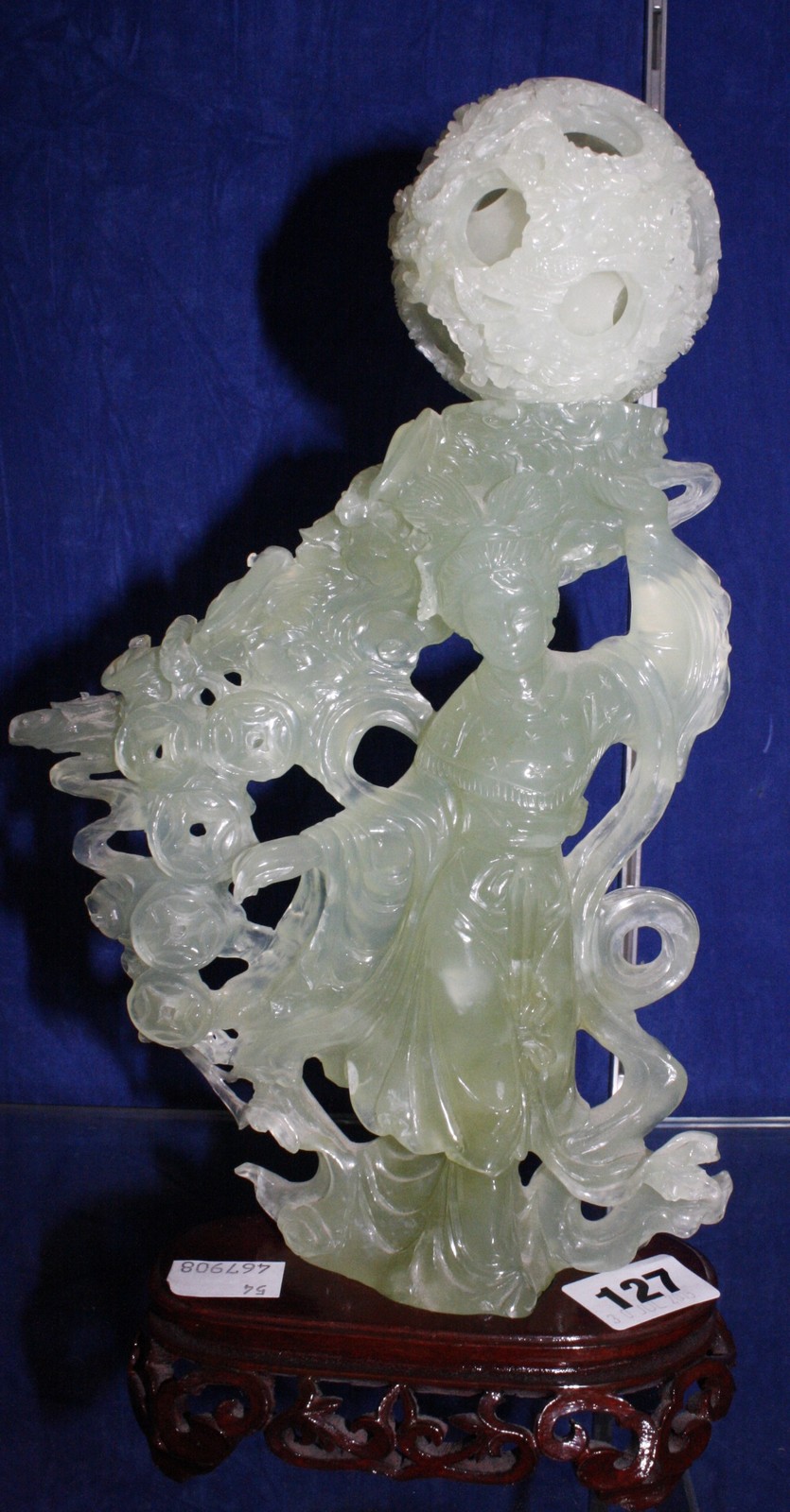 A modern Jadeite carving of figure and puzzle ball, on wooden stand, (af), 32cm high