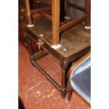An 18th Century and later oak side table with a frieze drawer on ring turned legs joined by