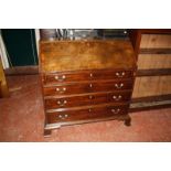 A George III mahogany bureau, the sloping fall enclosing an arrangement of drawers and pigeon holes,