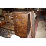 An oak five drawer chest, pair of Victorian oak dining chairs and an oak blanket chest