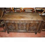 A late 17th Century oak coffer, with a hinged lid, the central panel with stylized floral decoration