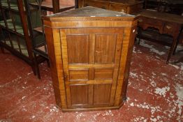 A 19th century mahogany corner cupboard with blind dentil frieze 78cm wide