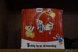 A Chinese made battery operated Teddy Bear Drumming in its original box.