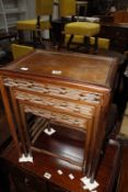 A nest of three Chinese hardwood tables, the largest 44cm wide