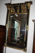 A Regency ebonised and gilt overmantel mirror, the frieze with five classical figures in relief,