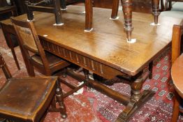 A 20th Century oak dining table, on turned legs joined by central stretcher 153cm length