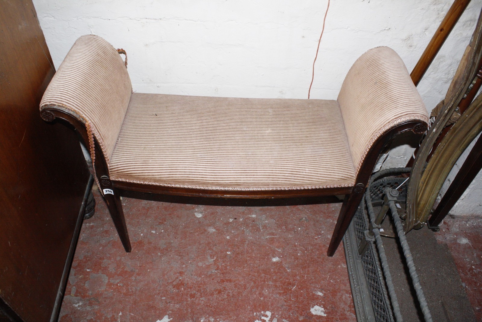 A mid 19th Century mahogany window seat with swept ends raised on tapered supports.