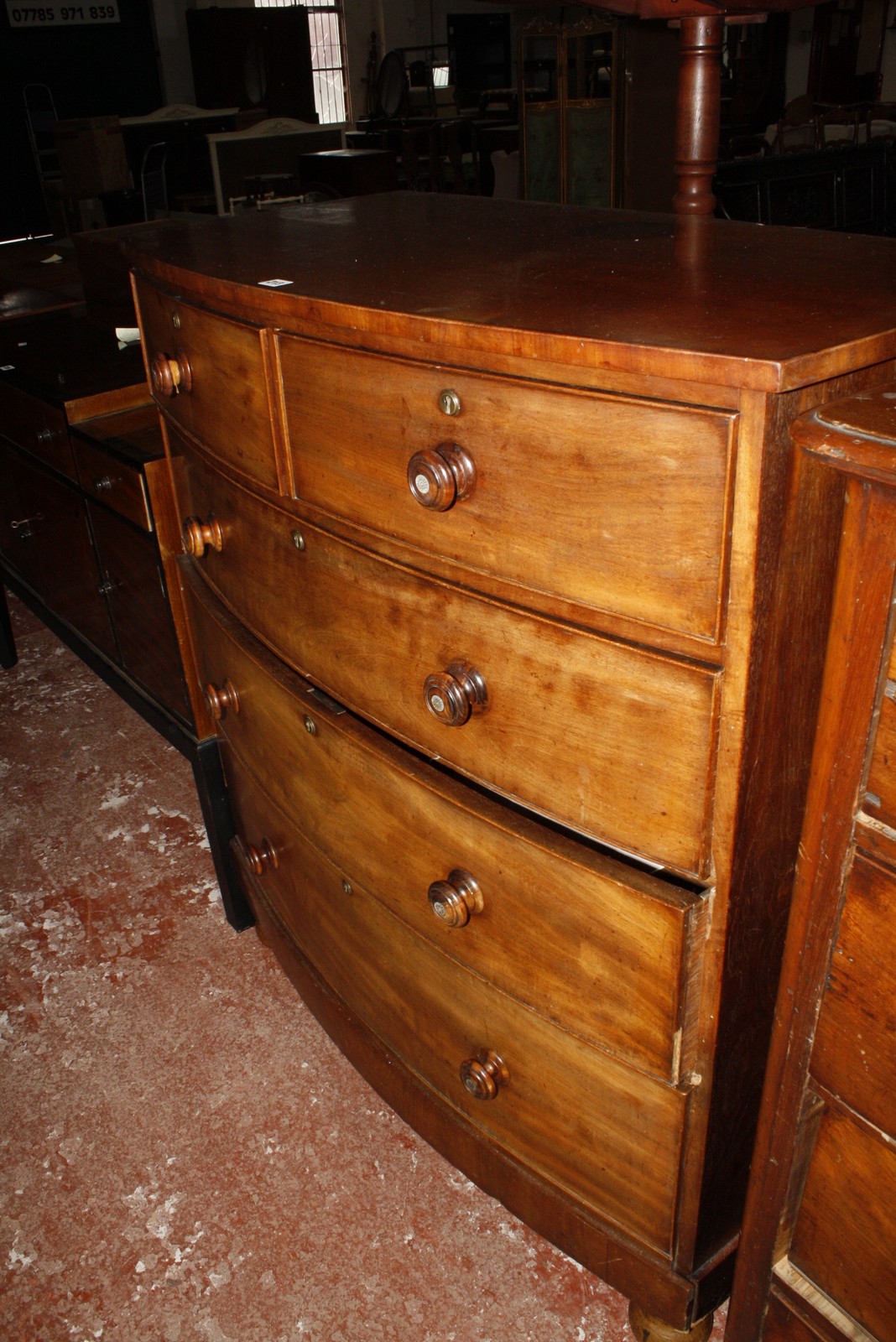 A 19th Century mahogany bowfront chest with two short and three long drawers on bun feet 108cm wide