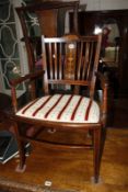 An Edwardian elbow chair with floral inlay to the splat.