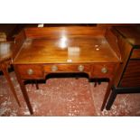 An early 19th Century mahogany kneehole side table, with three quarter gallery, three short