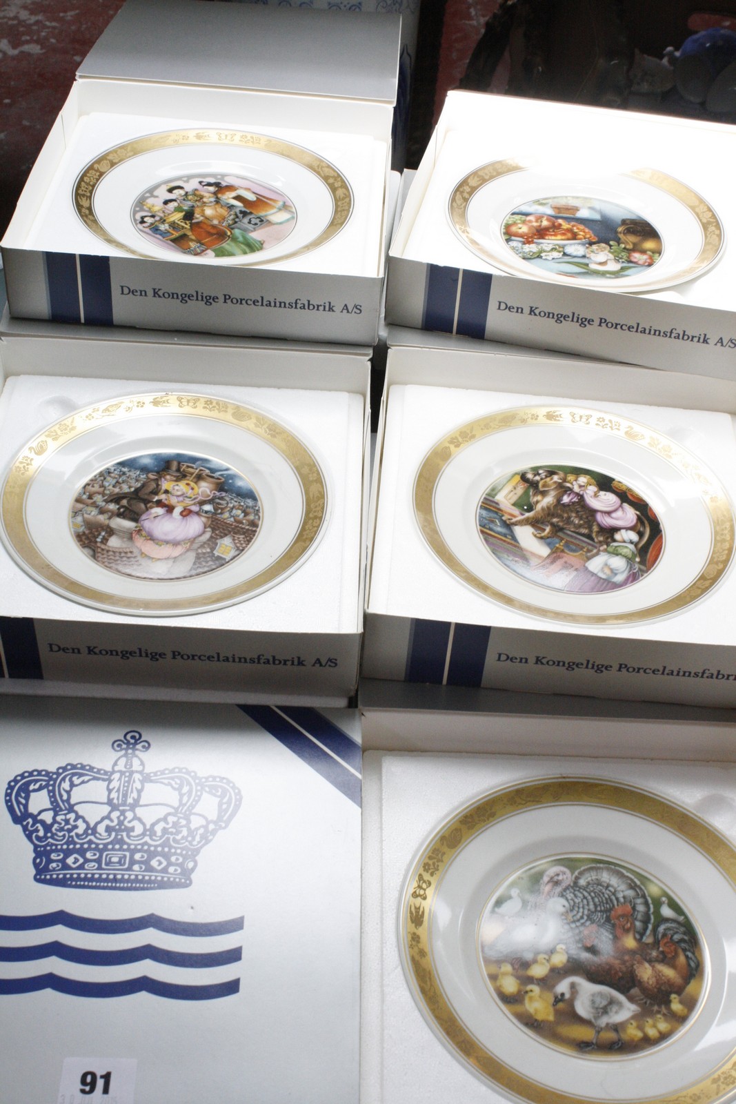 Twelve Royal Copenhagen plates depicting scenes from Hans Christian Andersen tales (boxed).