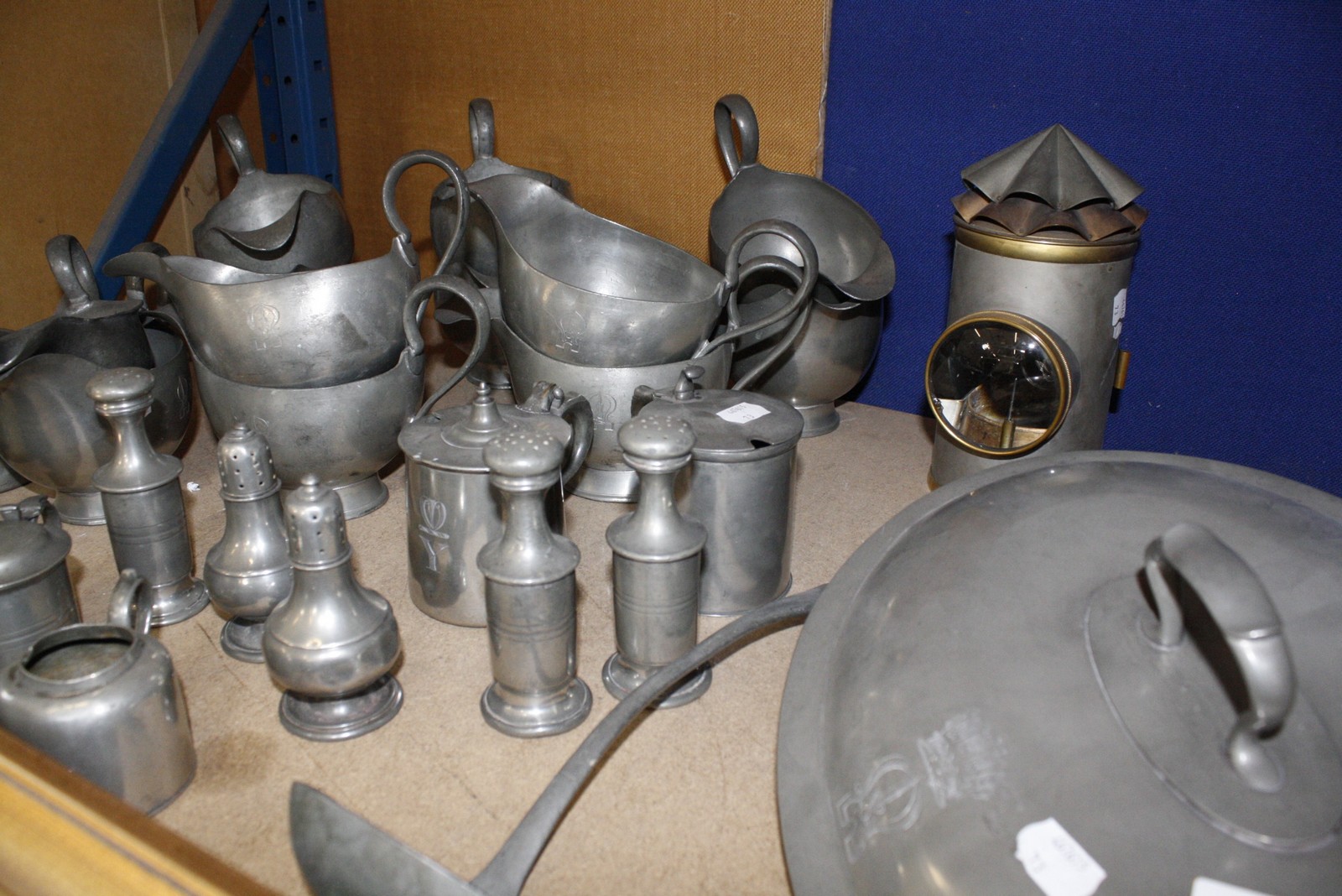 A quantity of pewter items to include condiments, gravy boats, tankards, tureen covers etc and a