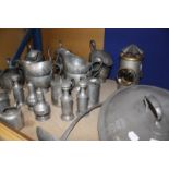 A quantity of pewter items to include condiments, gravy boats, tankards, tureen covers etc and a