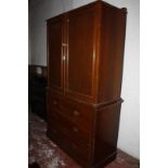 A late 19th/early 20th Century mahogany linen press, the upper doors enclosing linen slides with