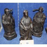 Three bronze Chinese Immortals, 28cm high approx.
