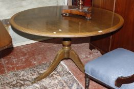 A Regency style mahogany round table on a swept pedestal base.121cm diam, a reproduction mahogany