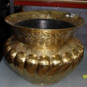 A hammered brass log bin, gadrooning and foliate decoration, 40cm high and 47.5cm in diameter