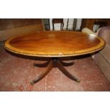 A Regency style mahogany and satinwood crossbanded oval centre table on pedestal base 155cm wide,