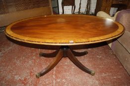 A Regency style mahogany and satinwood crossbanded oval centre table on pedestal base 155cm wide,