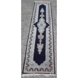 A Persian Kirman runner 291 x 72cm Best Bid