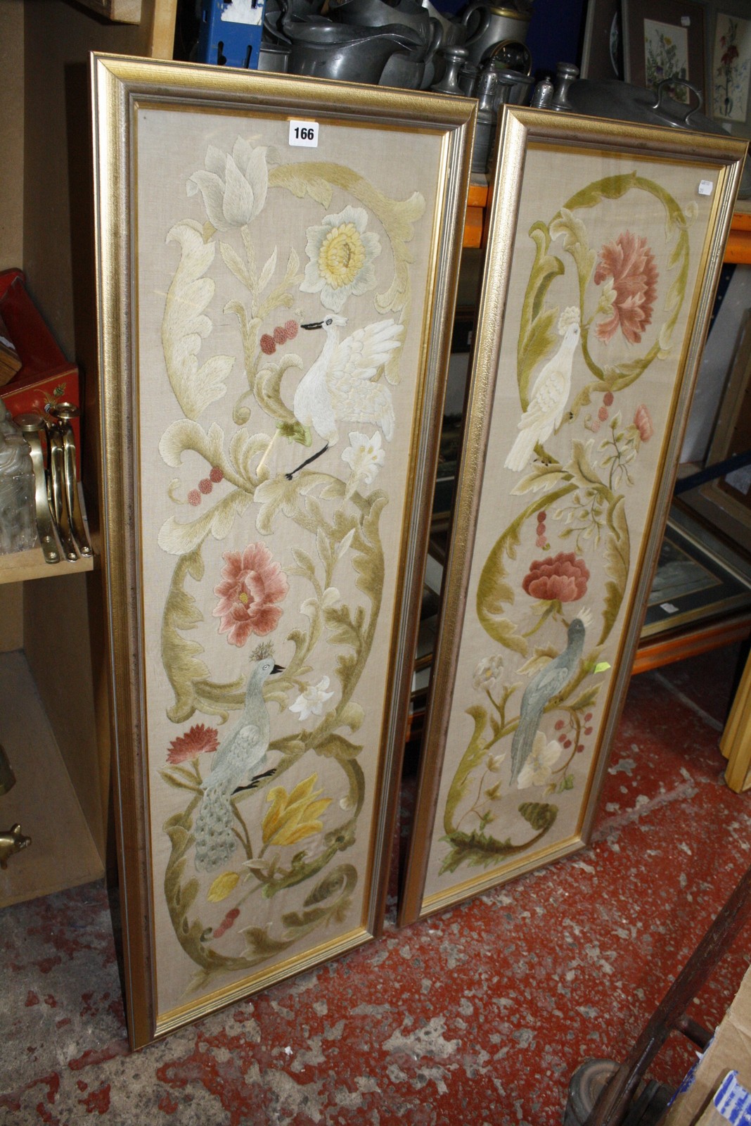 A pair of 19th Century embroidered panels on linen, wool embroidery, depicting birds amongst floral,