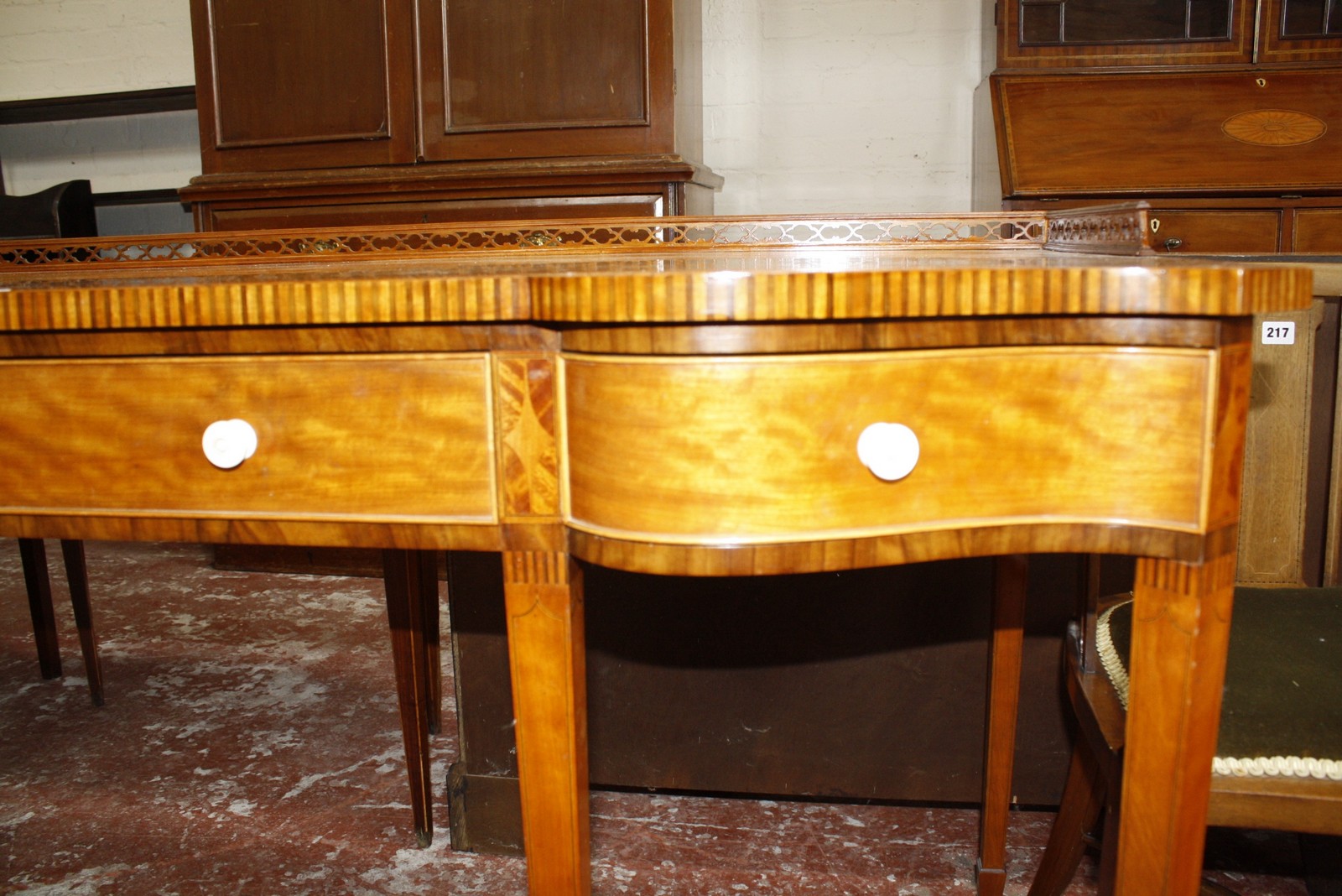 A Sheraton style satinwood and crossbanded writing desk, with a shaped top and three quarter - Image 2 of 2