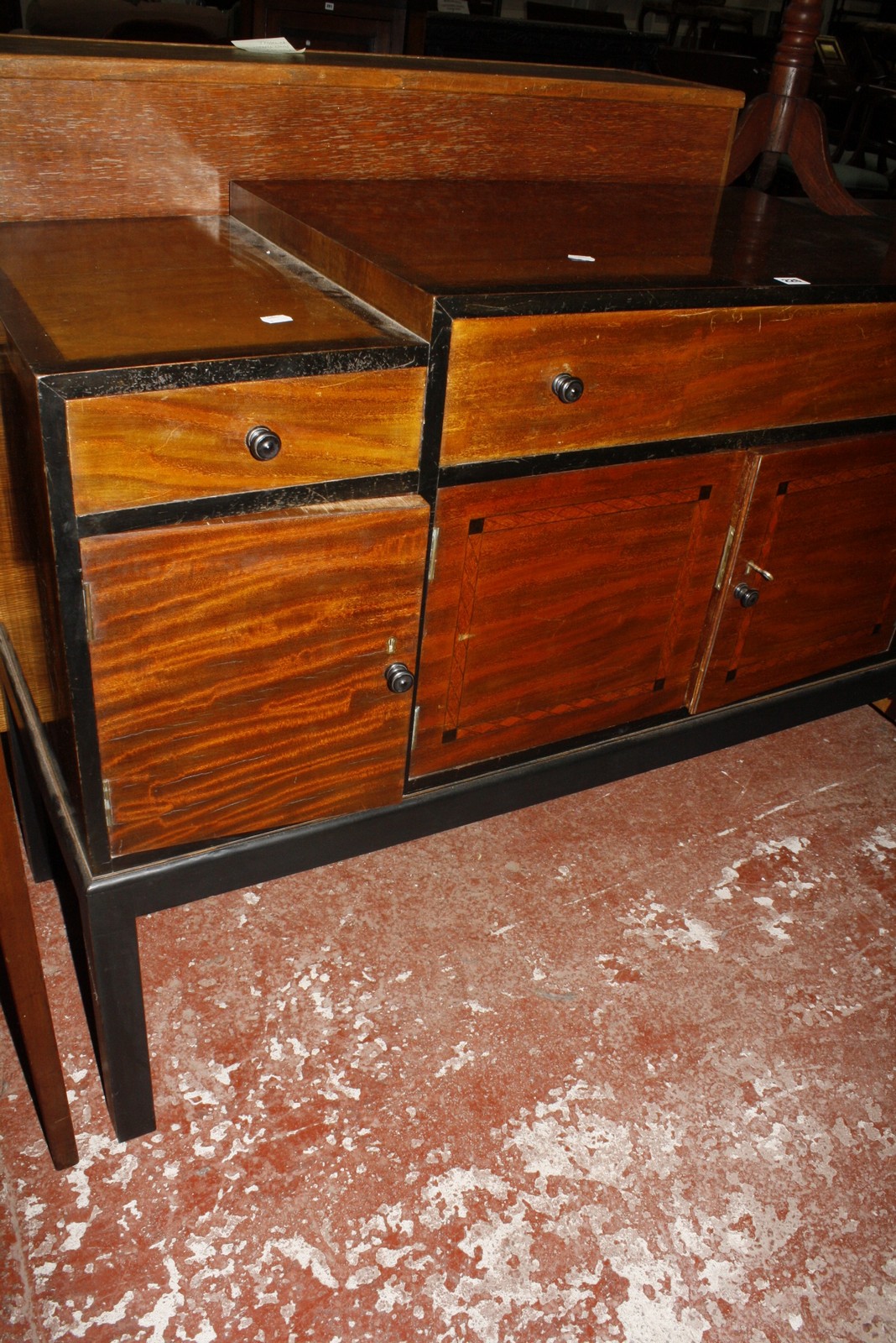 A Heals ebonised and mahogany sideboard, with a stepped top, three short drawers and cupboards below - Image 2 of 3