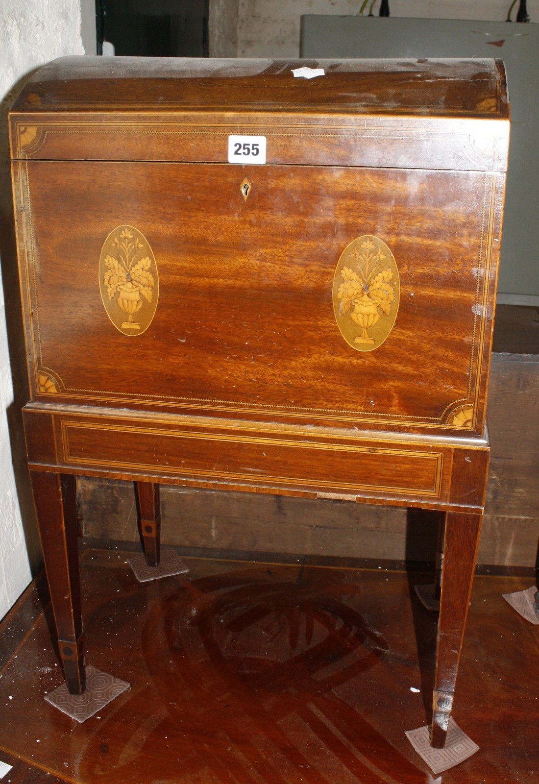 A 19th Century inlaid mahogany cellarette, with domed top on square tapering legs 44cm wide