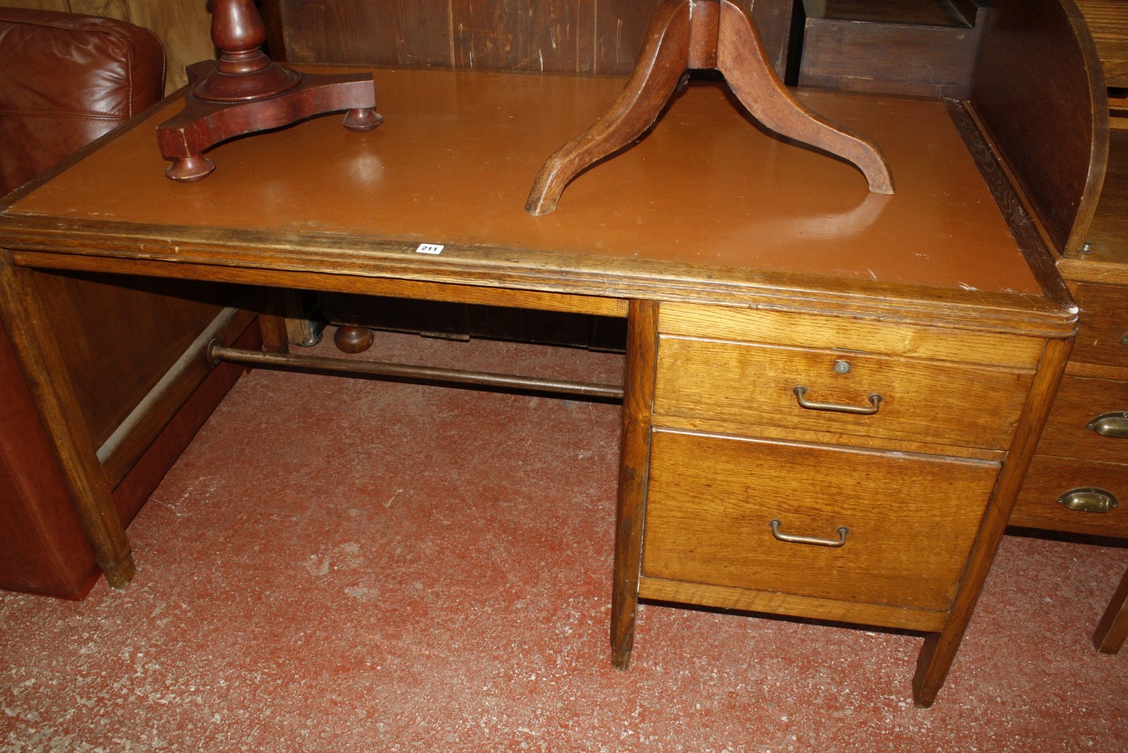 An early 20th Century oak desk, with inset writing surface and two drawers 77cm high, 152cm wide